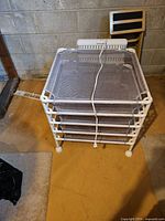 Stacked dryer showing five mesh trays and heating unit attached