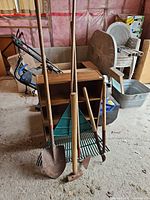 Group of all five yard tools leaning together