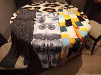 All three maxi dresses laid on table showing patterns and colours