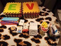 Overview of foam mats, flash cards, Spot It! tin, cube fan and tubs with accessories