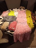 All eight garments laid on table showing packaged and unpackaged items