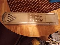 full view of silver metal pool cue rack on wooden surface