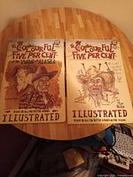 Front covers of both magazines showing titles, artwork and signatures