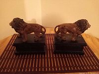 Side view of both lion bookends on bases