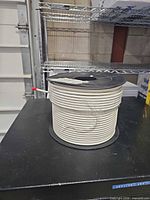 Full view of white coaxial cable on spool