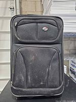 Front view of black American Tourister softside suitcase