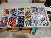 All 12 comic books laid out on table