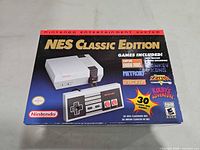 Front of NES Classic Edition retail box showing console image and features