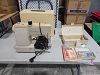 Full view of Singer sewing machine, case, pedal, accessory box, manuals