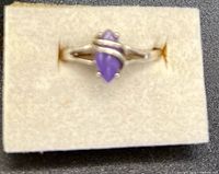 Front view of sterling silver ring with purple marquise stone on foam pad