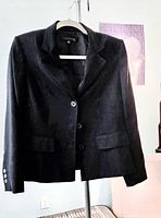 Front view of navy blazer on hanger