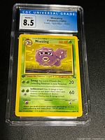 Front of CGC slab showing Weezing card and CGC 8.5 grade label