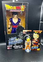 Front view of both packaged figures: Gohan boxed, Goku carded