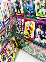 Binder opened showing multiple modern football cards in nine-pocket sleeves