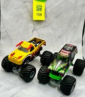 Front angled view of both Grave Digger and El Toro Loco trucks