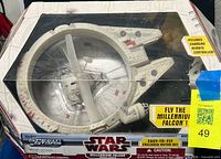 Front of retail box displaying Millennium Falcon RC vehicle through window