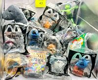Overview of bin showing multiple sealed McDonald’s bags, Marvel comic and Mario bag