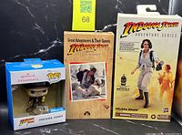All three packaged items side by side: ornament, VHS, action figure