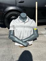Front view of mannequin torso outdoors with scale stick