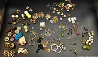Full tray view showing majority of earring pairs and shoe clips