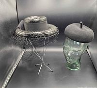 Both hats side by side on stands