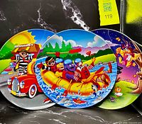 Front view showing three overlapping themed plates