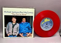 Front view of picture sleeve and red vinyl record
