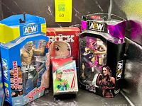 Group shot of all four packaged wrestling collectibles