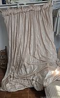 Full view of beige balloon curtain panel hanging