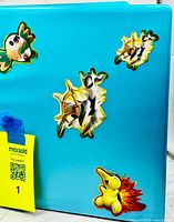 Front of blue binder with Pokémon stickers