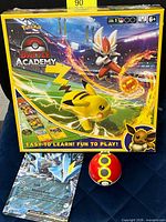 Front view of Battle Academy box, Kyurem EX jumbo card, Poké Ball toy