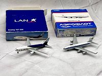 Both diecast airplane models with their original boxes