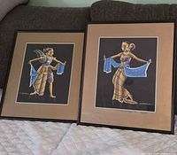 Both framed portraits side by side on couch