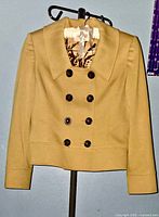 Front view of mustard yellow Tahari blazer showing buttons and collar