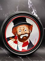 Full view of framed porcelain plate with clown artwork