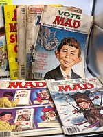 Stack of ten MAD Magazines showing various covers including Vote MAD and puzzle artwork