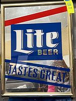 Full view of front of framed Miller Lite mirror sign showing graphics and frame