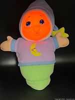 Front view showing glowing face, outfit colors, crescent moon embroidery