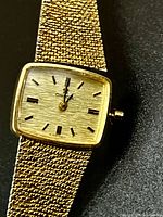 Front view of Omega De Ville watch showing textured dial, case and bracelet