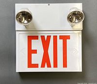 Front view of exit sign with two lamps