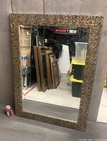 Front view of rectangular mirror with gold textured frame