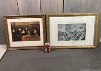 Both framed prints side by side with soda can for scale