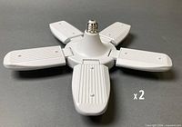 Foldable LED garage light showing ribbed gray housing and E26 screw base