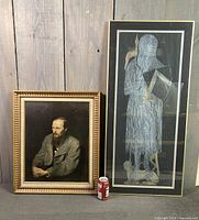 Both framed prints side by side with soda can for scale