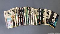 All 31 books arranged spine-out on flat surface