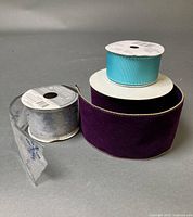 Three ribbon spools grouped together showing colors and spool fullness
