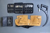 All four items: tool belt, spade bit set, hole saw kit, hacksaw frame