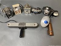 Group shot of five cameras, Porta Bar bracket, handheld flash