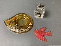 Overall lot showing ashtray, lighter, bird