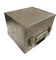 Angled view of square silver metal case showing ribbed texture, handle, and latches